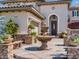 Close-up of an elegant home entrance with a fountain, lush landscaping and stone accents at 2038 Cherry Creek Cir, Las Vegas, NV 89135