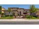 Elegant home featuring a well-manicured lawn, stone accents, and a charming fountain at 2038 Cherry Creek Cir, Las Vegas, NV 89135