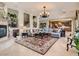 Spacious living room featuring a fireplace, staircase, and seamless open-concept design to the kitchen at 2038 Cherry Creek Cir, Las Vegas, NV 89135