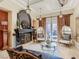 A view of the living room with a fireplace, unique chairs, stylish decor and tile floors at 2038 Cherry Creek Cir, Las Vegas, NV 89135