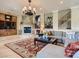 A spacious living room boasts a stone fireplace, elegant staircase, and comfortable seating for relaxation and gatherings at 2038 Cherry Creek Cir, Las Vegas, NV 89135