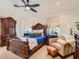 Elegant main bedroom featuring a ceiling fan, a sitting area and carved wood furniture at 2038 Cherry Creek Cir, Las Vegas, NV 89135