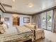 Bright main bedroom featuring french doors to a patio, neutral decor, and ensuite bathroom access at 2038 Cherry Creek Cir, Las Vegas, NV 89135