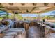 Under a covered patio, a fully equipped outdoor kitchen features a grill, sink, bar seating, and stunning views at 2038 Cherry Creek Cir, Las Vegas, NV 89135
