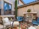 Relaxing outdoor living space featuring a stone fireplace, comfortable seating, and decorative landscaping at 2038 Cherry Creek Cir, Las Vegas, NV 89135