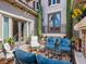 Charming outdoor patio with cozy seating, decorative plants, and access to the home's interior at 2038 Cherry Creek Cir, Las Vegas, NV 89135