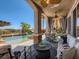 Covered poolside patio with ceiling fan, lounge chairs, and scenic views at 2038 Cherry Creek Cir, Las Vegas, NV 89135
