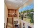 Upper staircase showcasing a large landscape art piece and a built-in buffet bar at 2038 Cherry Creek Cir, Las Vegas, NV 89135