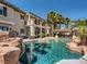Back of house with swimming pool and rock features, gazebo, and palm trees at 2038 Cherry Creek Cir, Las Vegas, NV 89135