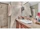 Bathroom featuring stone-look tile shower and vanity at 2200 S Fort Apache Rd # 1007, Las Vegas, NV 89117