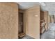 Condo hallway leading to the door of Unit 1007 with a convenient rack for packages at 2200 S Fort Apache Rd # 1007, Las Vegas, NV 89117