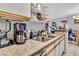 Kitchen area featuring granite countertops, shelves, and stainless steel appliances at 2200 S Fort Apache Rd # 1007, Las Vegas, NV 89117
