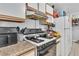 Functional kitchen with white appliances and tile flooring, providing a practical cooking space at 2200 S Fort Apache Rd # 1007, Las Vegas, NV 89117