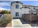 Charming two-story home with stucco exterior, arched windows and a concrete driveway at 2736 Stargate St, Las Vegas, NV 89108