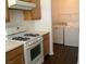 A kitchen with light wood cabinets, countertops, and a stove with a laundry area at 2736 Stargate St, Las Vegas, NV 89108