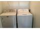 Bright laundry area features a white washer and dryer set with overhead shelving at 2736 Stargate St, Las Vegas, NV 89108