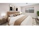 Warm bedroom featuring a luxurious bed with gold accents and a view to the trees outside the window at 2851 S Valley View Blvd # 1150, Las Vegas, NV 89102