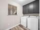 Bright laundry room with modern washer and dryer, plus ample storage in dark cabinets at 2851 S Valley View Blvd # 1150, Las Vegas, NV 89102