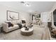 Comfortable living room featuring a couch, rug, and table with a view of the kitchen and a white front door at 2851 S Valley View Blvd # 1150, Las Vegas, NV 89102