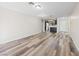 Open-concept living room with hardwood floors seamlessly transitions into the kitchen at 2851 S Valley View Blvd # 1150, Las Vegas, NV 89102