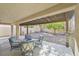 Covered patio area with outdoor furniture and a gravel landscaped backyard at 301 Treehouse Ct, Henderson, NV 89012