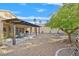 A backyard featuring a covered patio and easy-care desert landscaping at 301 Treehouse Ct, Henderson, NV 89012