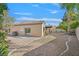 A view of the backyard, highlighting its desert landscape and covered patio at 301 Treehouse Ct, Henderson, NV 89012