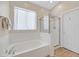 Clean bathroom featuring soaking tub with shower and white cabinets at 301 Treehouse Ct, Henderson, NV 89012