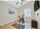 Bedroom with ceiling fan, wood flooring and a window with white shutters, perfect for a workout room at 301 Treehouse Ct, Henderson, NV 89012