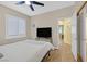 This light-filled bedroom has wood floors, plantation shutters, and a TV at 301 Treehouse Ct, Henderson, NV 89012