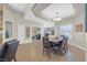 Bright open-concept dining area featuring wood floors, tray ceilings, and modern decor at 301 Treehouse Ct, Henderson, NV 89012