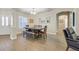 Bright dining area with wood floors, modern lighting, and stylish shutters on the front door at 301 Treehouse Ct, Henderson, NV 89012
