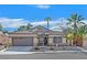 Charming single-story home with well-manicured landscaping and a two-car garage at 301 Treehouse Ct, Henderson, NV 89012