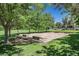 Recreational horseshoe pit with benches surrounded by lush greenery at 301 Treehouse Ct, Henderson, NV 89012