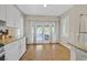 Bright kitchen nook with white cabinets, granite countertops, and french doors to patio at 301 Treehouse Ct, Henderson, NV 89012