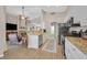 Bright open kitchen with white cabinets, granite countertops, and view of living area at 301 Treehouse Ct, Henderson, NV 89012