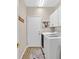 Bright laundry room featuring white washer and dryer, neutral paint and white cabinets at 301 Treehouse Ct, Henderson, NV 89012