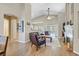 Cozy living room with a fireplace, wood floors, neutral paint, and an open-concept design at 301 Treehouse Ct, Henderson, NV 89012