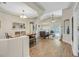 Open-concept living and dining area with wood floors, modern lighting, and comfortable seating at 301 Treehouse Ct, Henderson, NV 89012