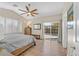 Serene main bedroom with wood flooring, ceiling fan, and bright window overlooking the backyard at 301 Treehouse Ct, Henderson, NV 89012