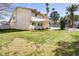 Large backyard with green grass, a covered patio, and mature landscaping at 3431 Iberia St, Las Vegas, NV 89146