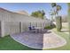 Landscaped backyard with brick-paved patio featuring an outdoor dining set, ideal for entertaining guests at 3431 Iberia St, Las Vegas, NV 89146