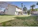 Expansive backyard with lush green grass, a covered patio, and a pool at 3431 Iberia St, Las Vegas, NV 89146