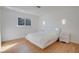Bedroom featuring light-colored walls, wood-like floors, and a comfortable queen bed at 3431 Iberia St, Las Vegas, NV 89146