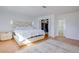 Bright bedroom featuring white walls, wood floors, a closet, and an ensuite bathroom at 3431 Iberia St, Las Vegas, NV 89146