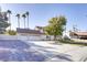 Home exterior featuring a three-car garage and brick-paved driveway at 3431 Iberia St, Las Vegas, NV 89146