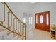 Inviting foyer featuring a decorative wood door, a staircase, and tiled flooring at 3431 Iberia St, Las Vegas, NV 89146