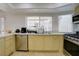 Bright eat-in kitchen with modern stainless steel appliances and a large window above the sink at 3431 Iberia St, Las Vegas, NV 89146
