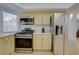 Kitchen featuring stainless steel appliances, light yellow cabinetry, and tile flooring at 3431 Iberia St, Las Vegas, NV 89146