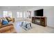 Bright living room with tile floors, comfortable sofa, and a large TV at 3431 Iberia St, Las Vegas, NV 89146
